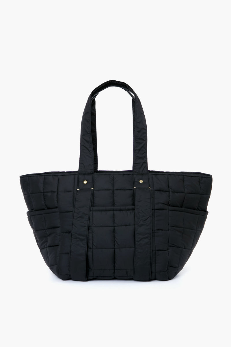 The Clare V black quilted tote bag features two handles, a rectangular shape, and grid stitching. Made from nylon, it’s both stylish and practical—ideal for carrying your essentials in a classic Clare V-inspired design.
