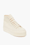 A cream high-top sneaker by Superga, crafted from organic canvas with a thick platform sole, lace-up front, and minimalist design—ideal for those who love the classic Superga style.