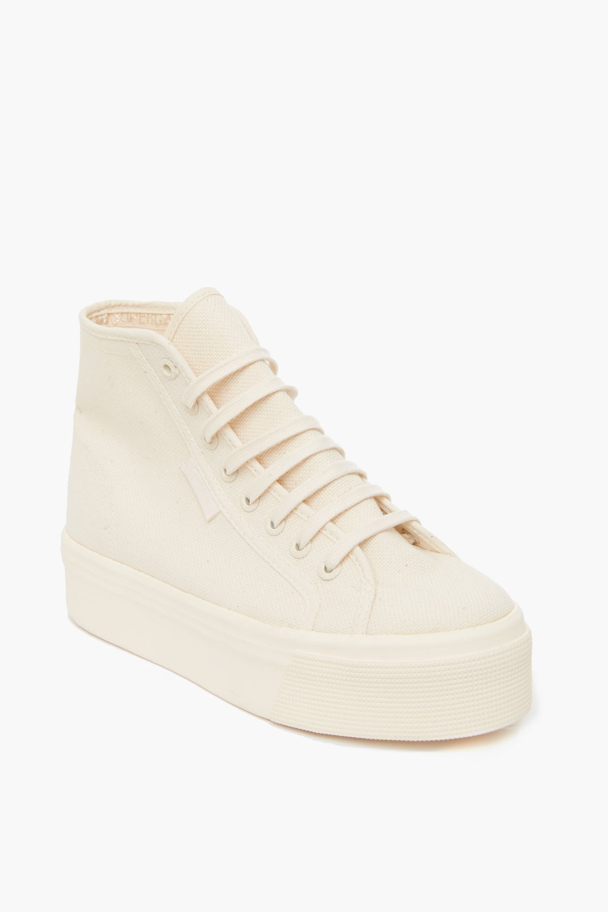 A cream high-top sneaker by Superga, crafted from organic canvas with a thick platform sole, lace-up front, and minimalist design—ideal for those who love the classic Superga style.