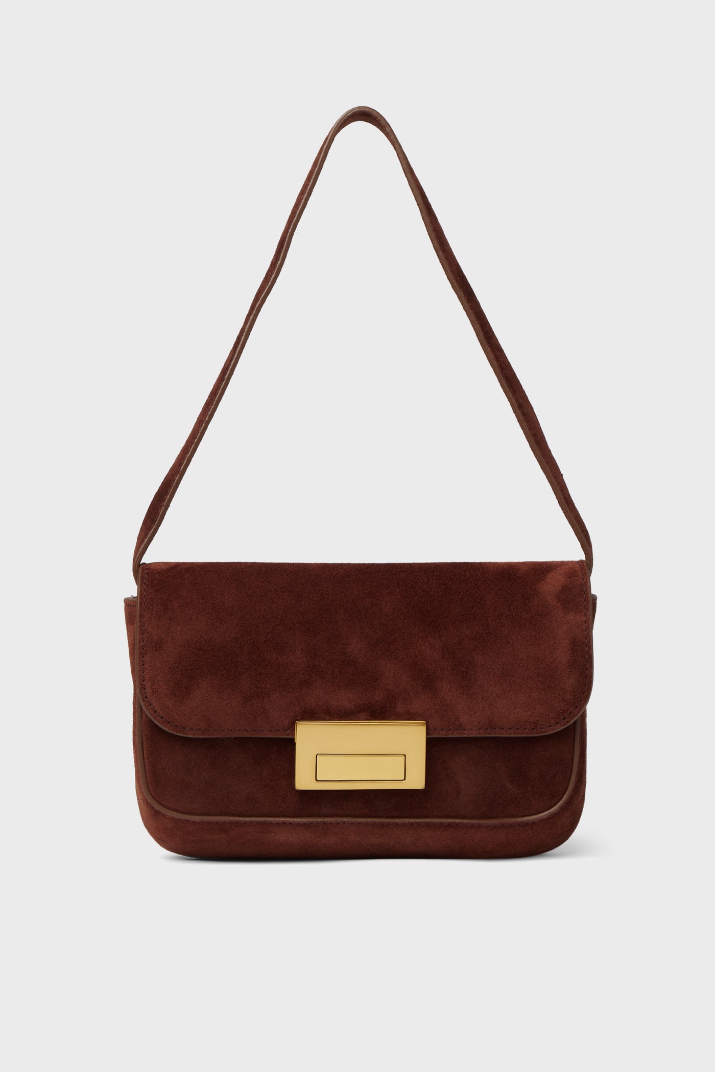 A brown suede baguette bag by Loeffler Randall, featuring a rectangular gold clasp and a single strap.