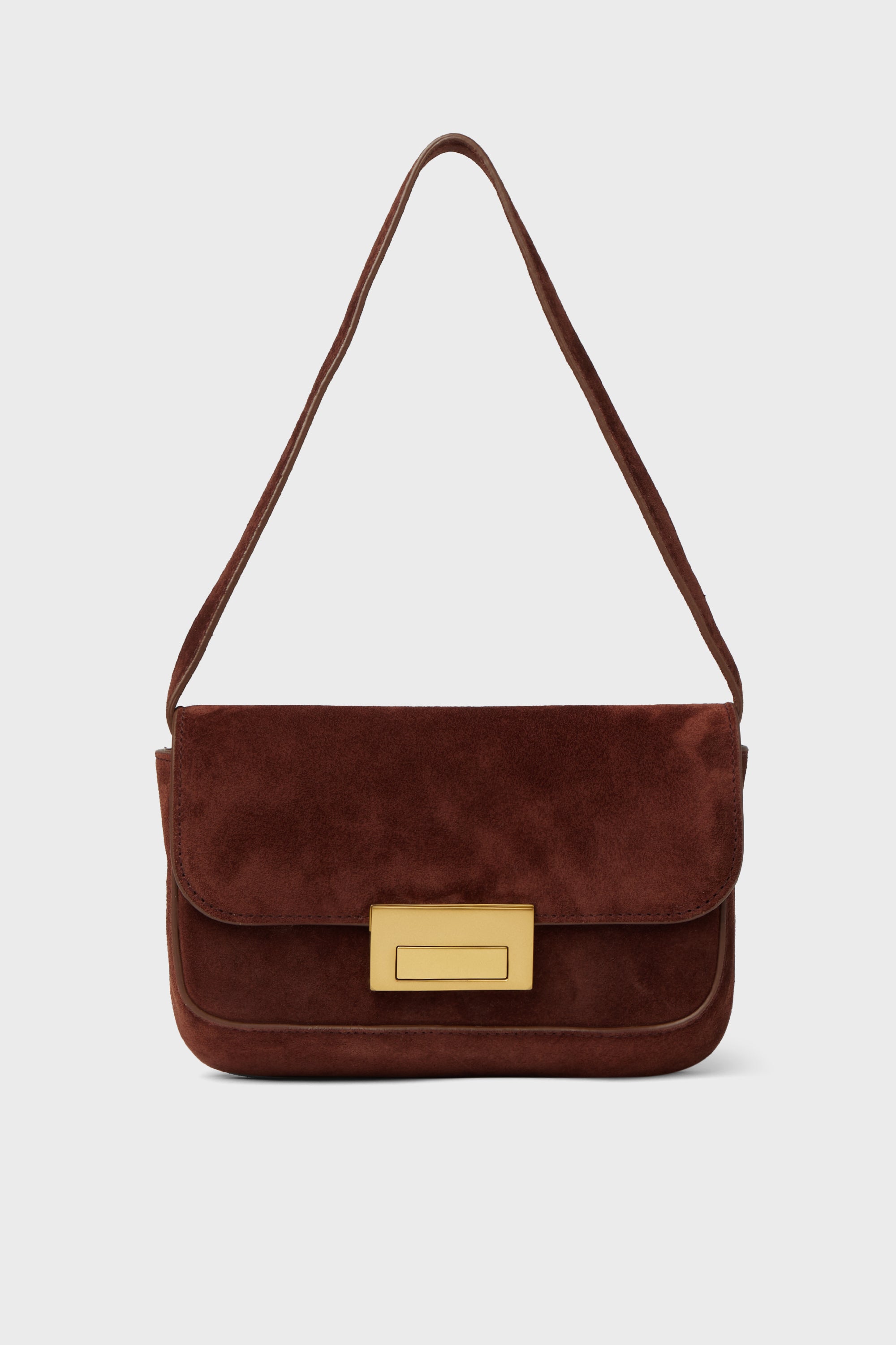 A brown suede baguette bag by Loeffler Randall, featuring a rectangular gold clasp and a single strap.