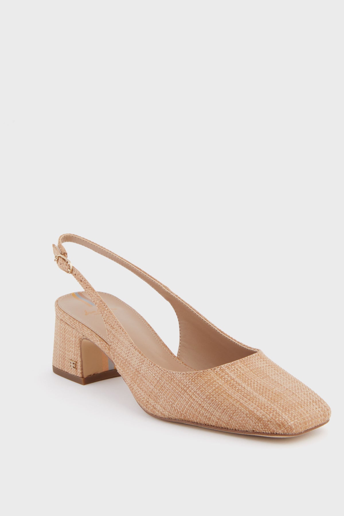 A tan raffia slingback by Sam Edelman featuring a low block heel, closed square toe, woven texture, and an adjustable strap.