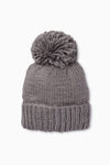 The Look by M gray pom beanie features a wide folded brim and a large pom-pom on top. This hand knit beanie adds cozy style to any outfit.