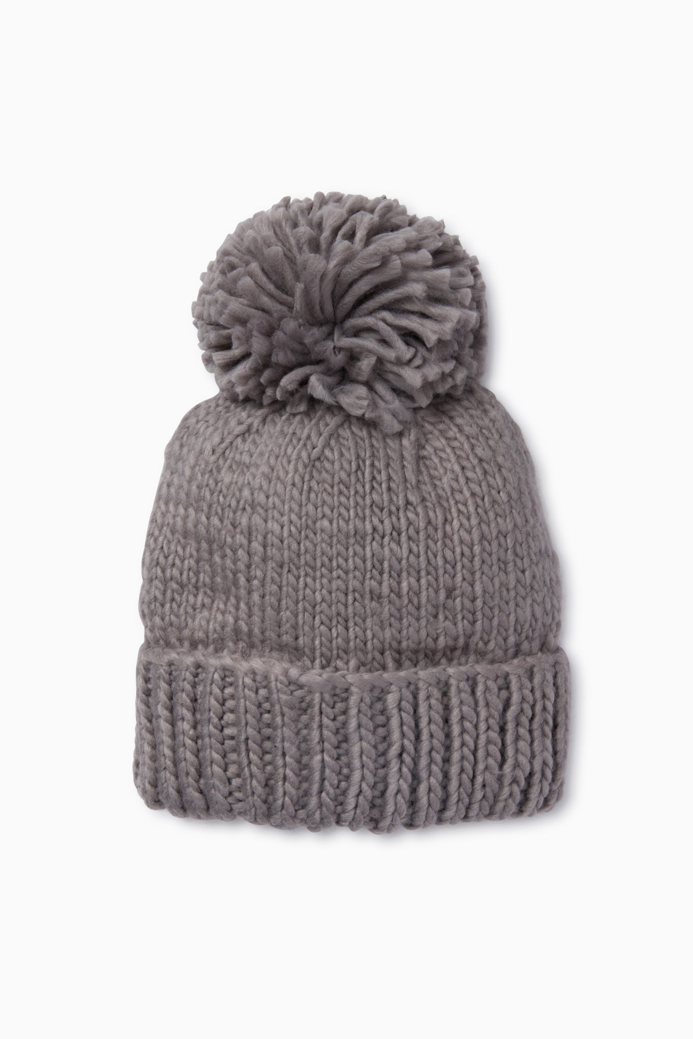 The Look by M gray pom beanie features a wide folded brim and a large pom-pom on top. This hand knit beanie adds cozy style to any outfit.