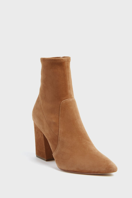 Tan suede ankle boots by Loeffler Randall, featuring a pointed toe, block heel, minimal design, and side zipper. Inspired by the Bracco Isla Slim Ankle Booties.
