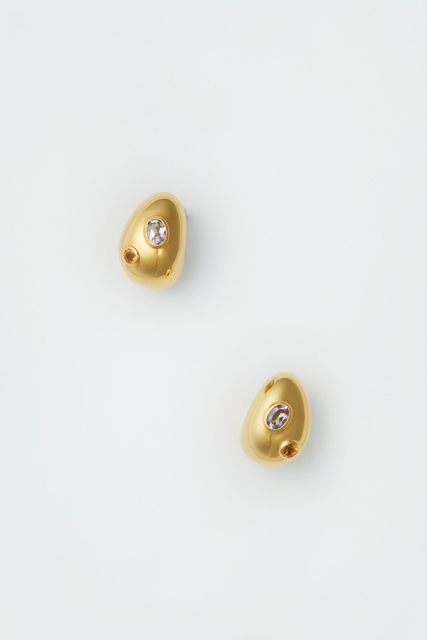 Lizzie Fortunato’s irregularly shaped gold mini arp earrings, each with a small semiprecious stone, celebrate the artistry of handcrafted jewelry.