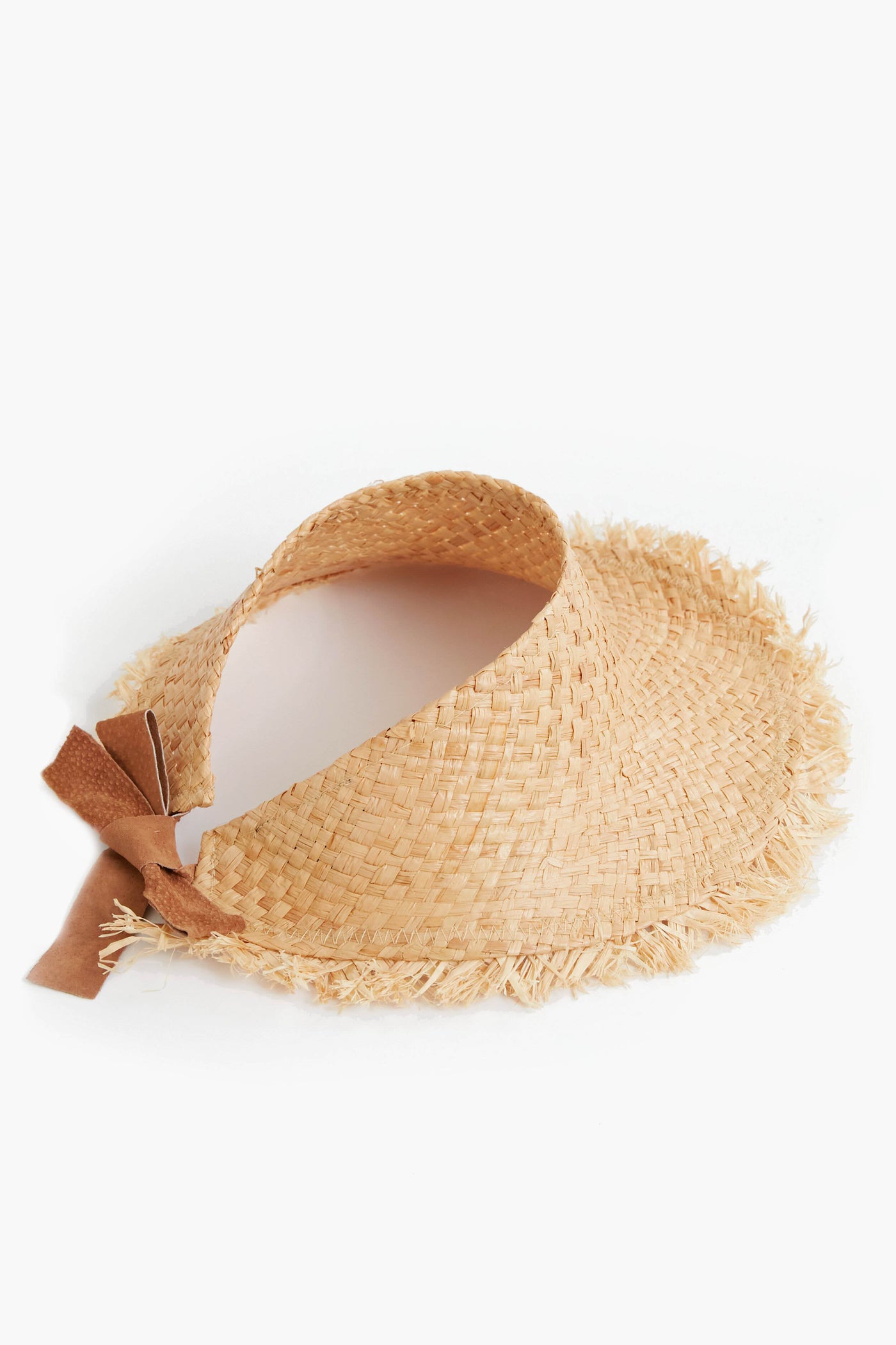 A woven raffia visor hat with a frayed brim and a brown suede bow accent on the side by Wyeth.