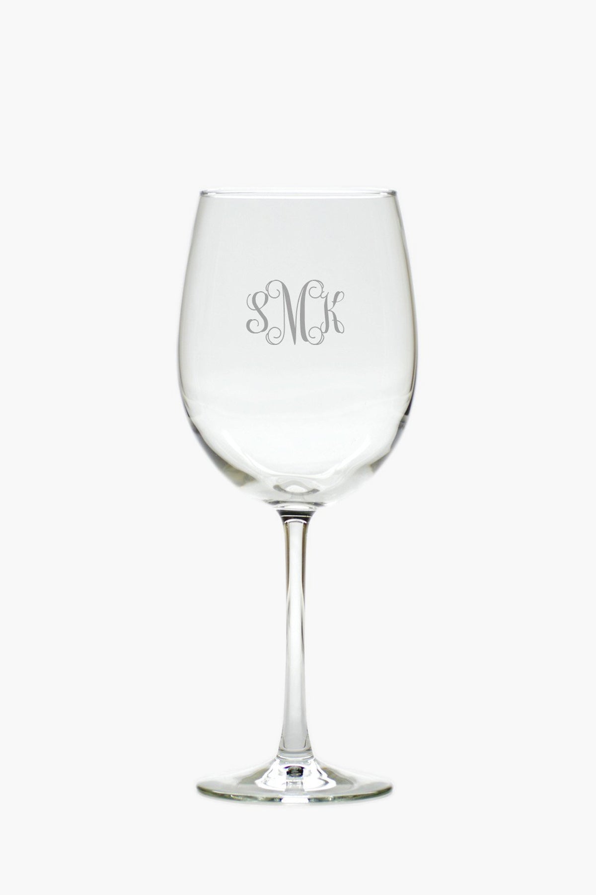 A clear tulip glass from Carved Solutions, engraved with the monogram SMK on its bowl, offers elegant personalized glassware.