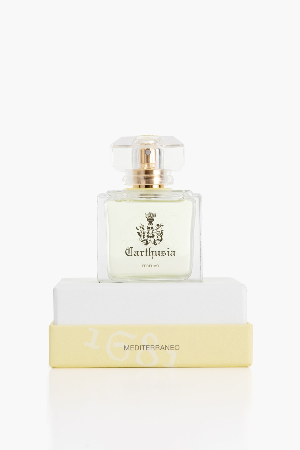A Carthusia Mediterraneo perfume bottle, featuring scents of lemon leaves and green tea, rests on a white and yellow box.