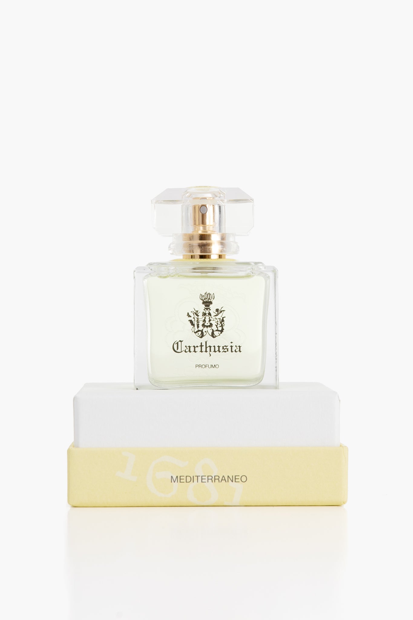 A Carthusia Mediterraneo perfume bottle, featuring scents of lemon leaves and green tea, rests on a white and yellow box.