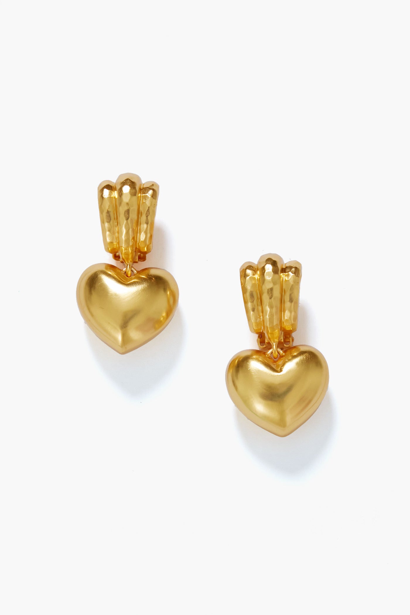 A pair of VALERE Gold Little Love Bubble Earrings featuring heart-shaped pendants with a textured three-bar design above each heart, crafted in 24k yellow gold. These elegant clip-ons add charm to any look.