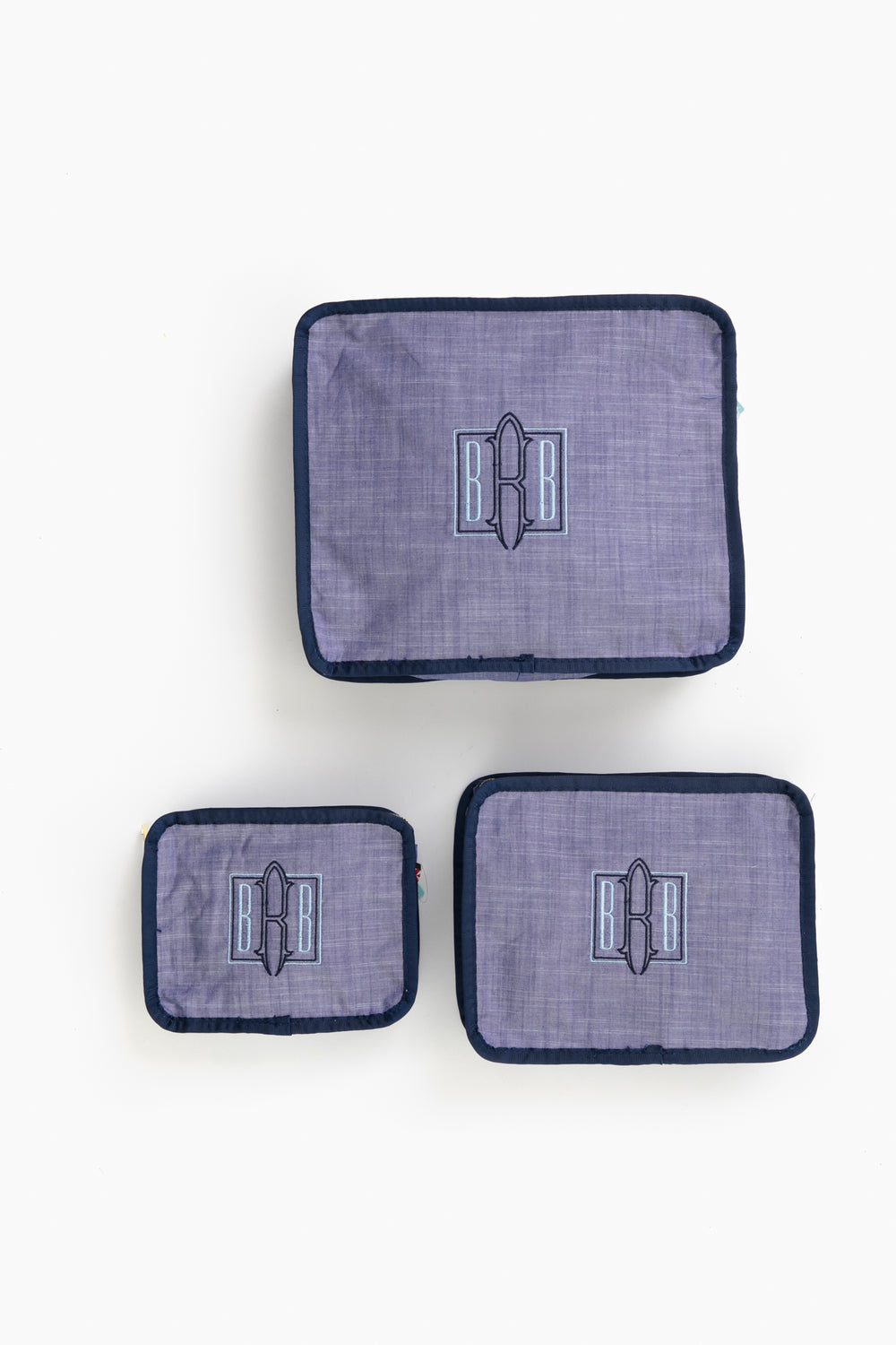 This Caton's Wharf Seersucker Travel Set includes three purple packing cubes with blue trim and a BB logo—an ideal bridesmaids gift.
