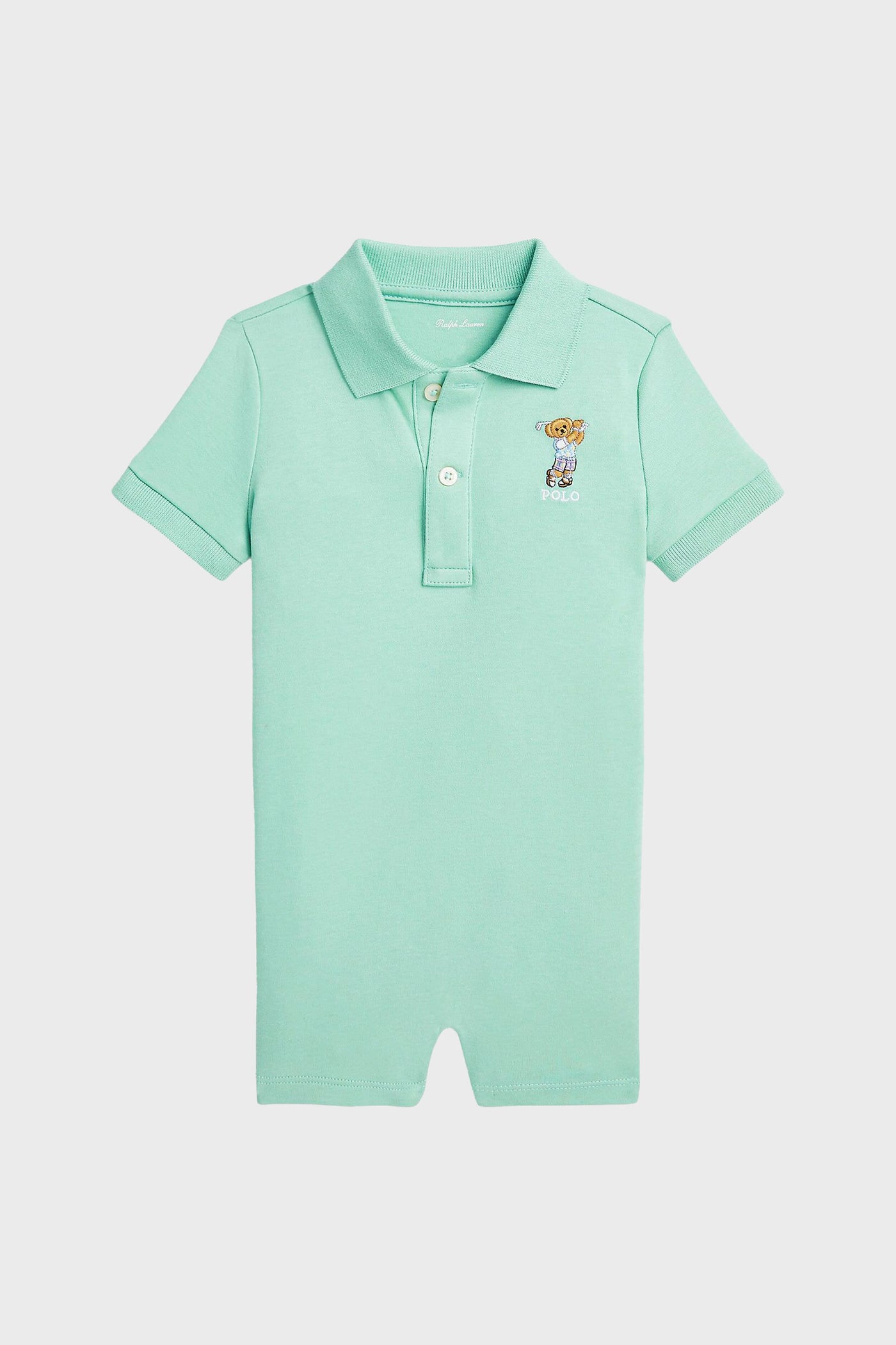 Light green cotton polo romper by Polo Ralph Lauren, featuring a collar, three buttons, and a small embroidered Polo Bear logo on the left chest—an iconic baby clothing piece.