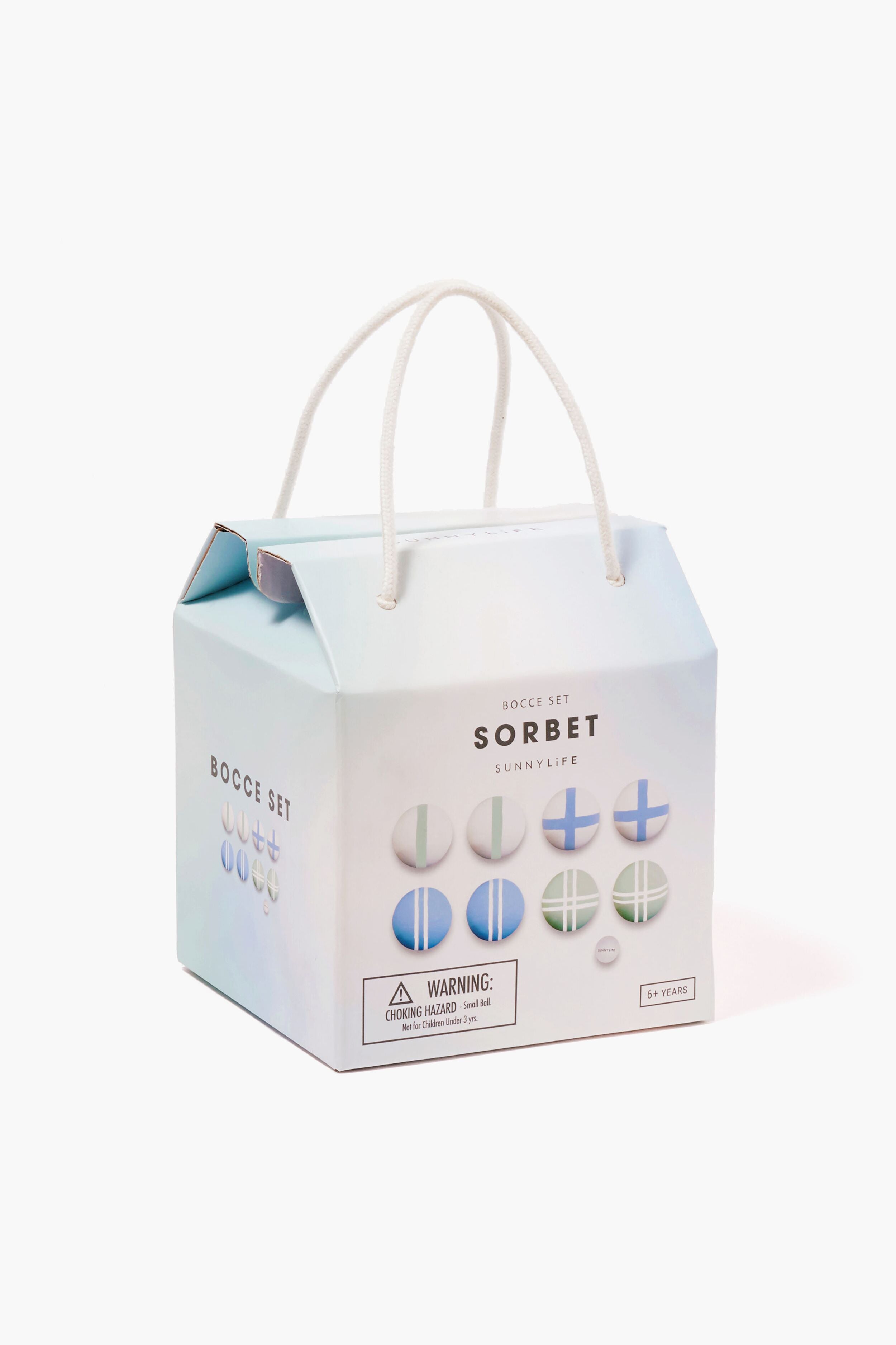 A pastel-colored Sunnylife Bocce Set Sorbet box with a rope handle, bocce ball images, and a warning label—ideal for summer essentials or as a fun outdoor beach bocce set.