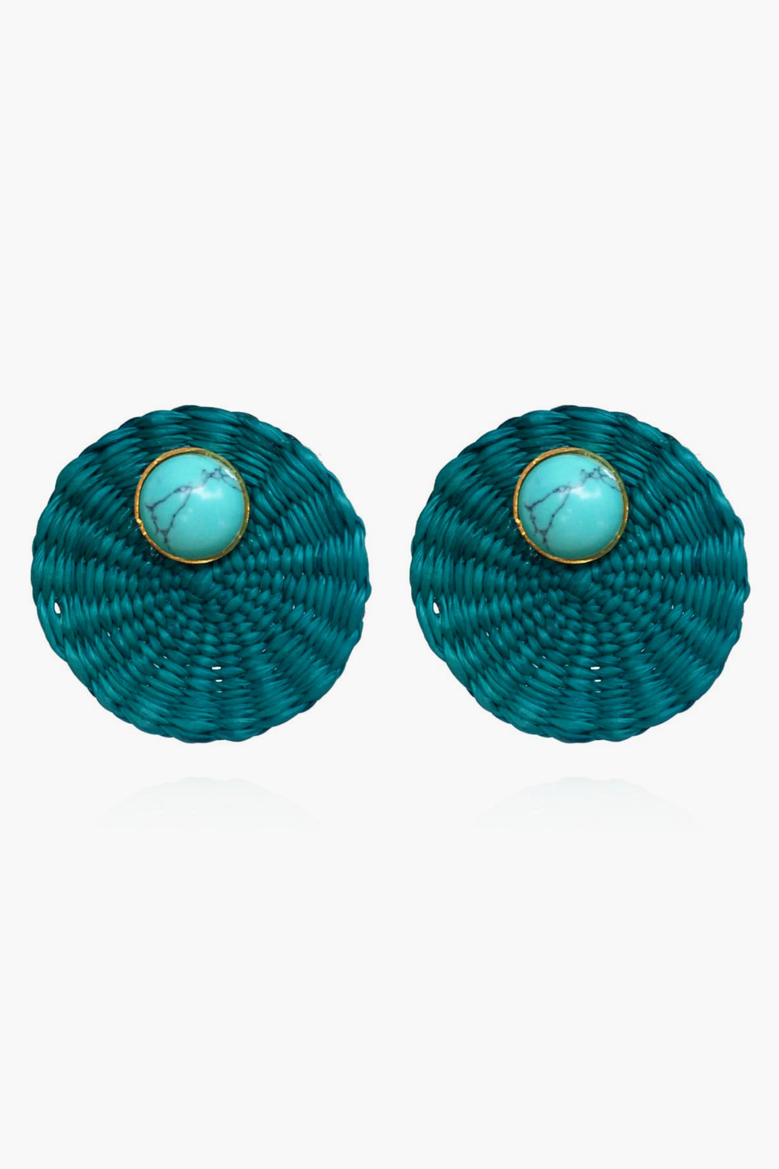 Ana Carolina Valencia round teal woven turquoise stud earrings feature a central turquoise stone framed by a thin gold-plated bronze rim—a stunning piece of handmade jewelry.