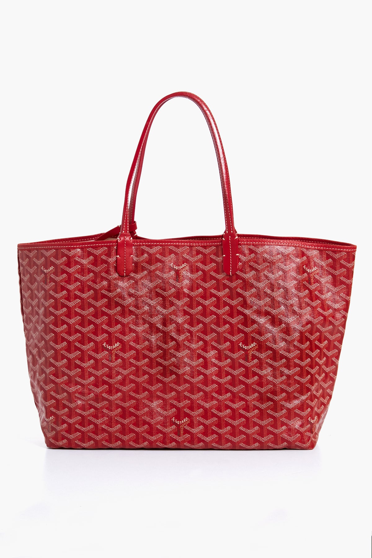 Red leather tote bag with dual handles and a patterned canvas exterior from Tuckernuck Archive Collection, inspired by the Goyard Saint Louis PM Tote.