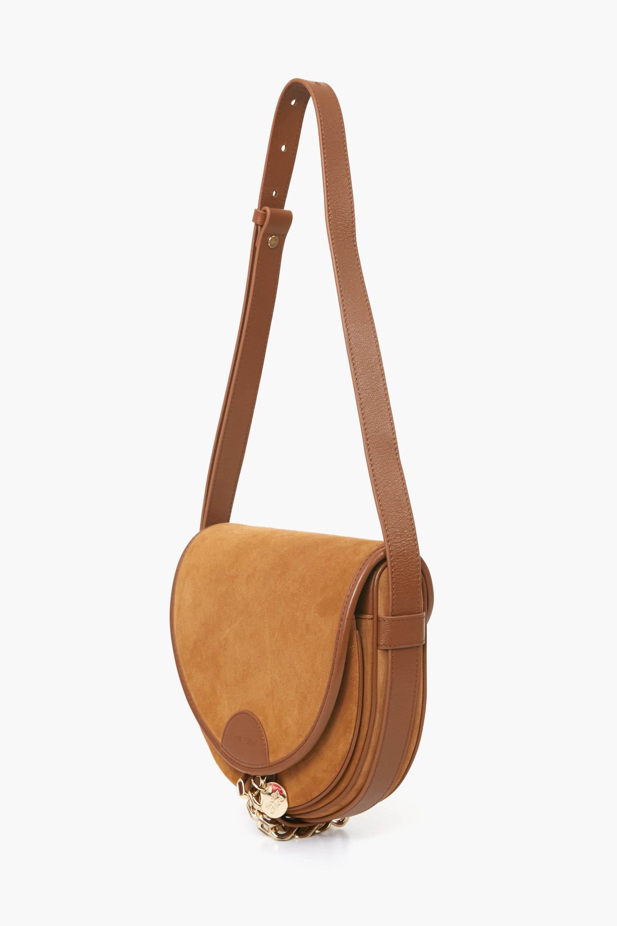 The See by Chloe Mara Bag is a tan cowhide leather and suede crossbody saddle bag featuring a flap closure, gold hardware, and an adjustable strap—blending timeless style with modern luxury.