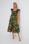 Woman in a Tuckernuck sleeveless, ankle-length Mallie Dress with a colorful floral print and beige open-toe heels—a perfect spring maxi dress.