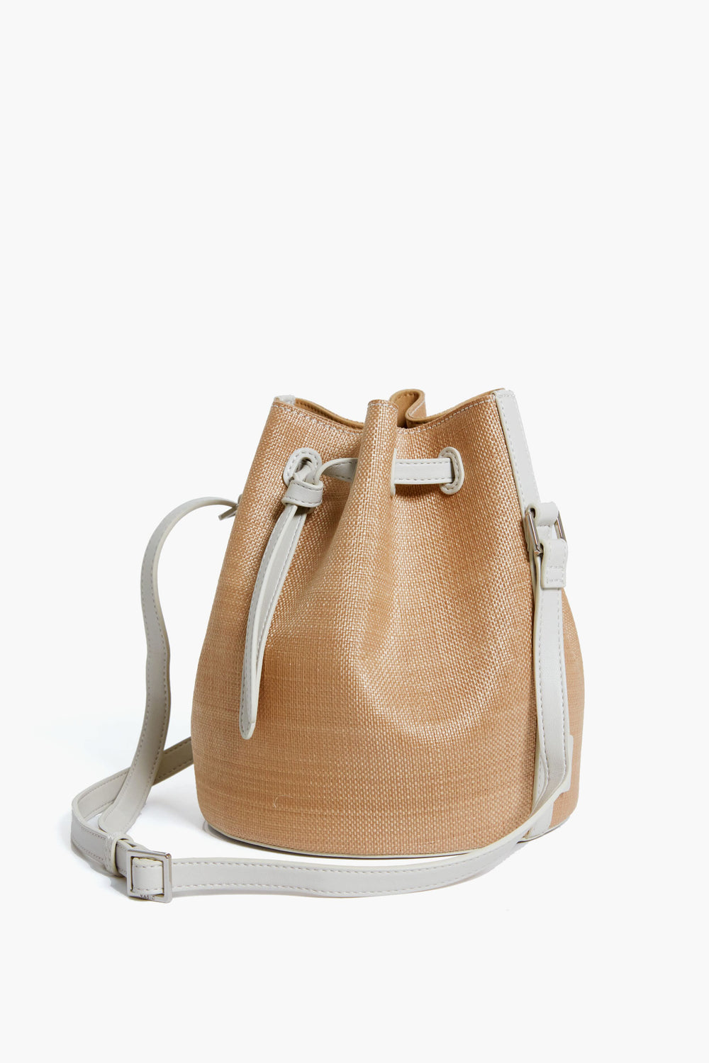 Vasic tan woven bucket bag featuring white leather trim, adjustable shoulder strap, and drawstring closure—a stylish crossbody purse crafted from durable raffia.