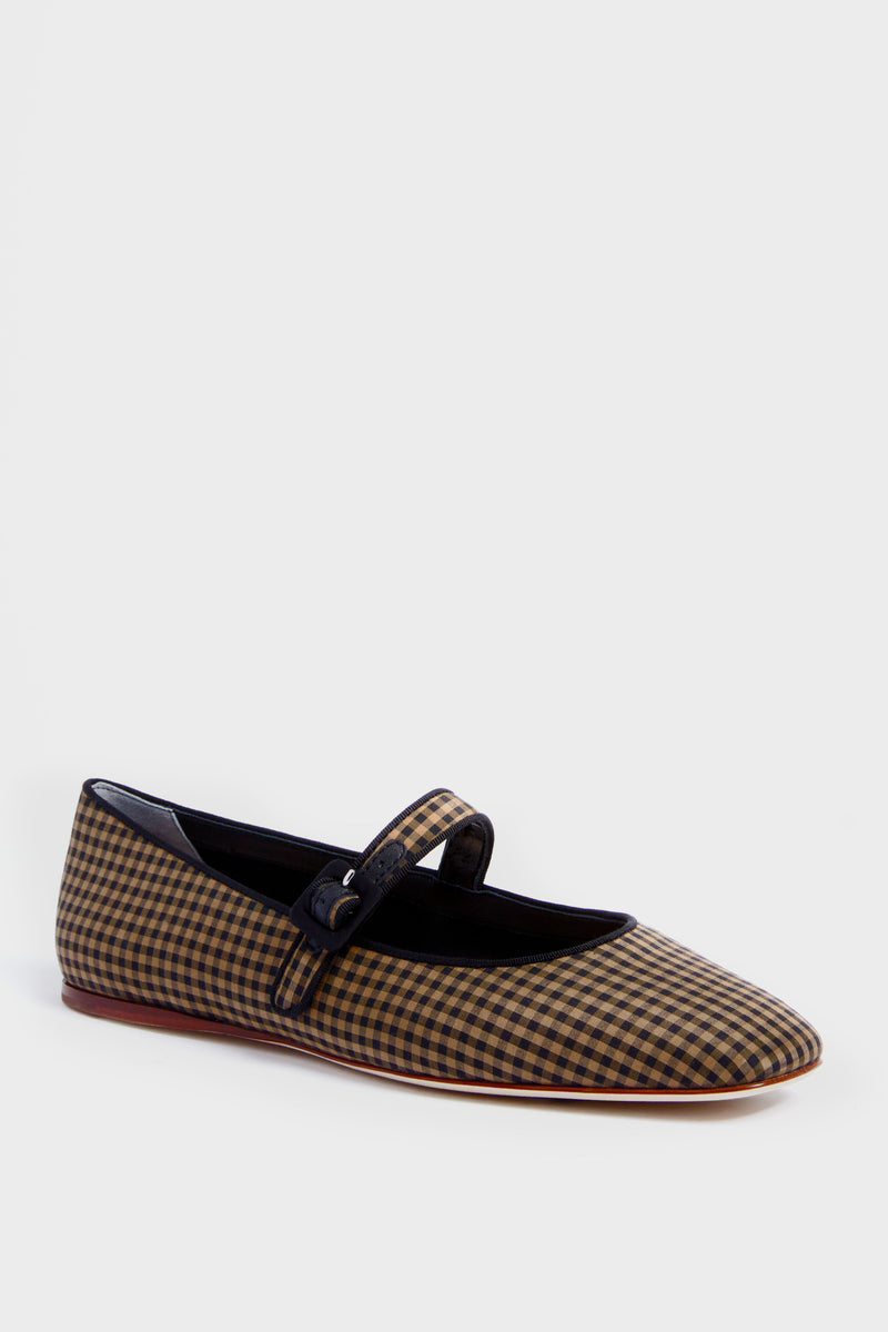 A single flat Mary Jane shoe by Loeffler Randall featuring a gingham check pattern, rounded toe, and buckle strap, inspired by the Black and Brown Check Ginger Flats.