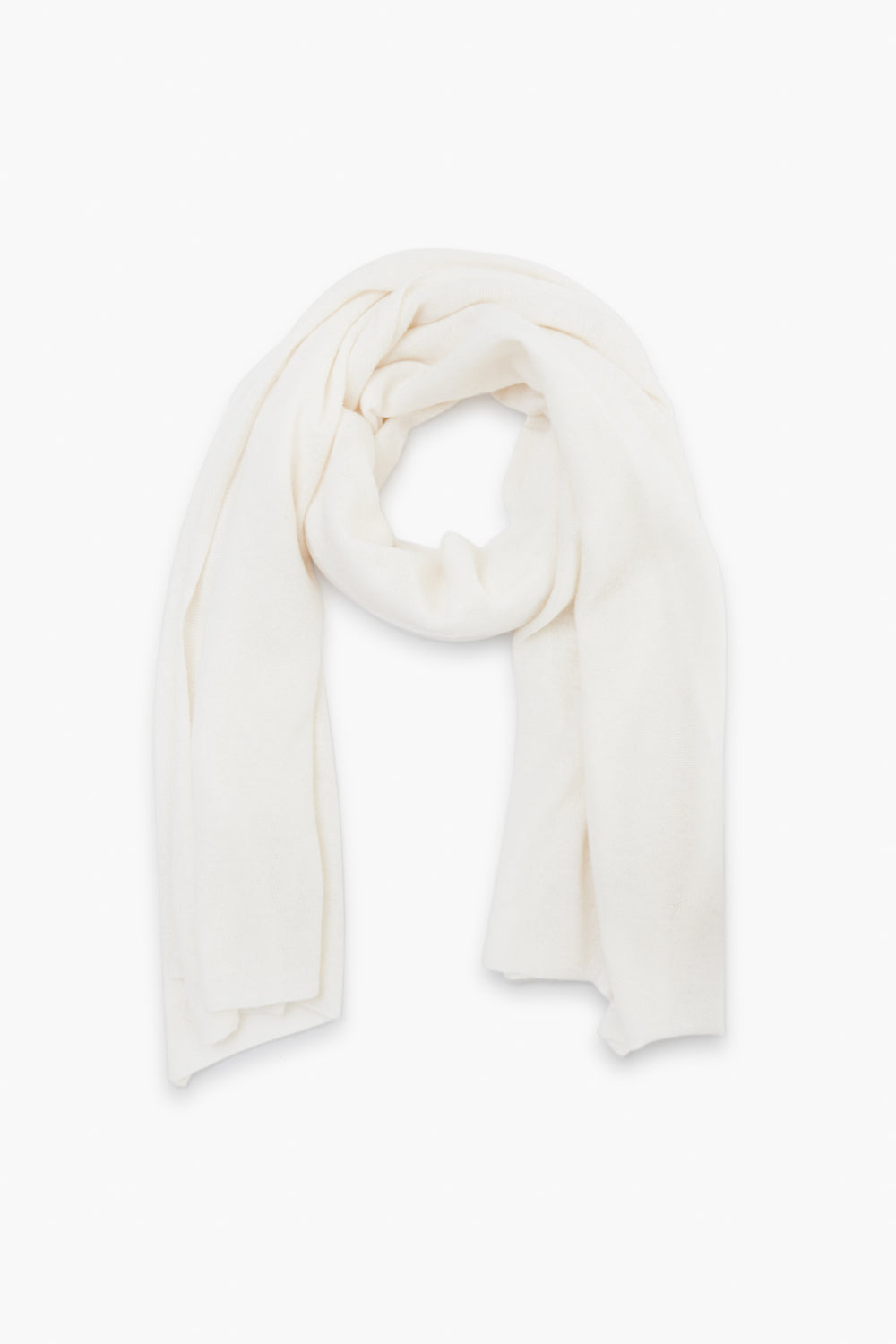 A soft, plain white cashmere travel wrap from White + Warren is neatly arranged in a loop.
