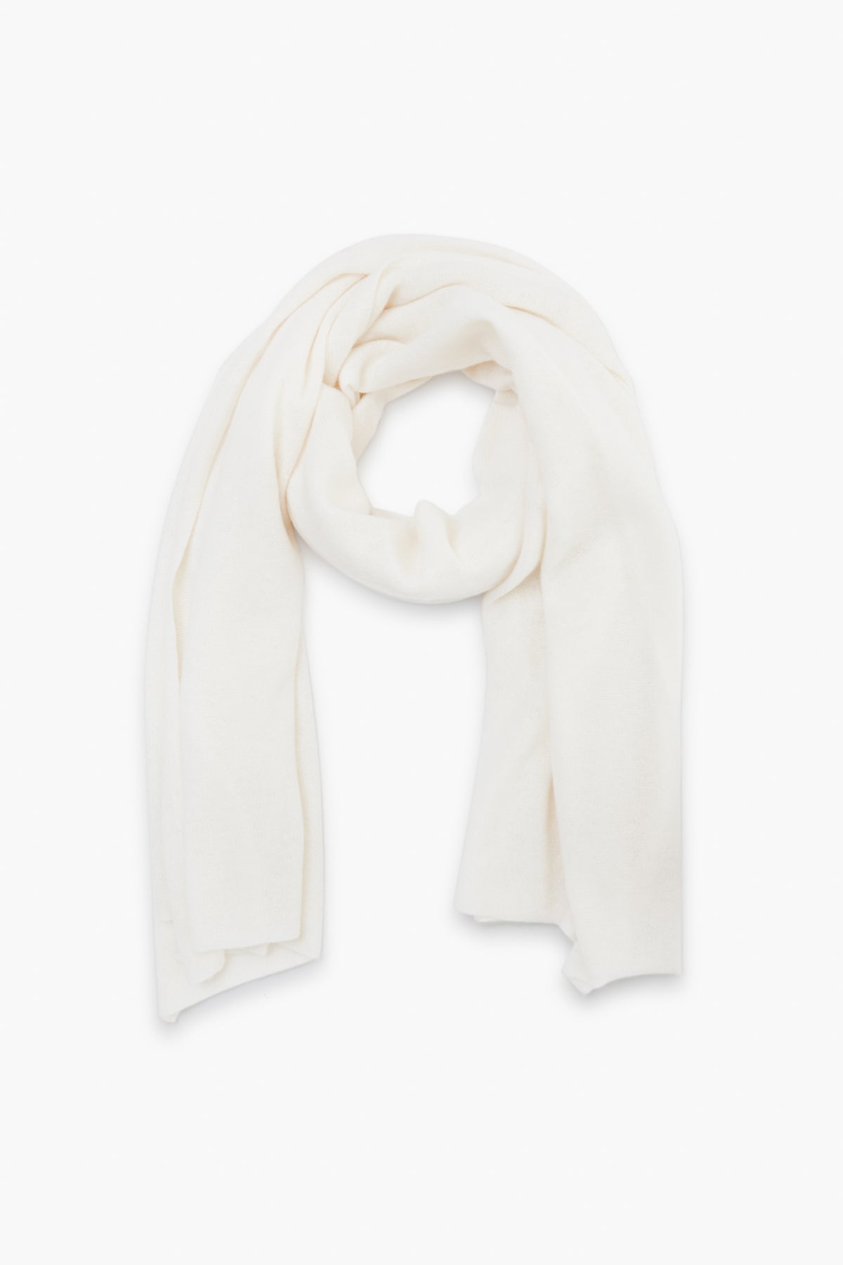 A soft, plain white cashmere travel wrap from White + Warren is neatly arranged in a loop.