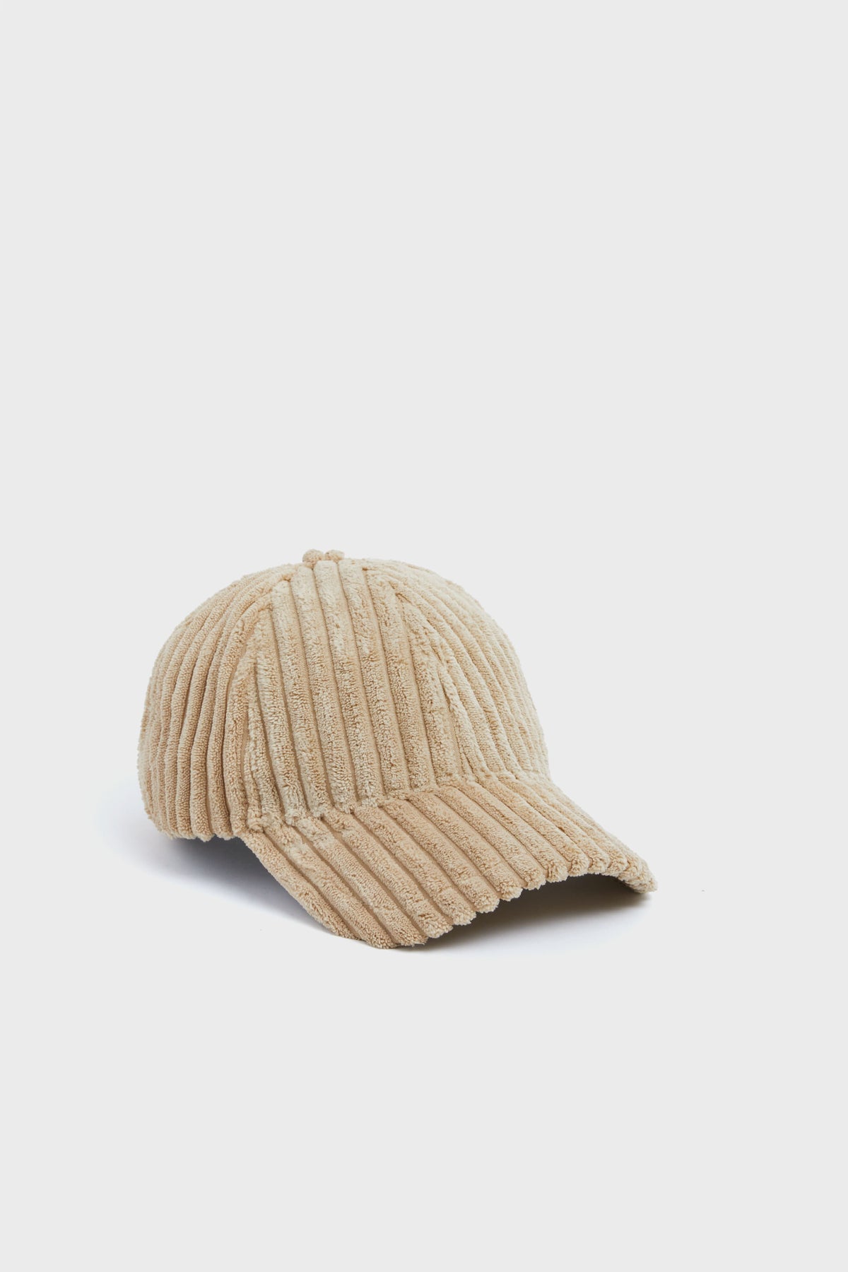 The Wyeth beige wide wale corduroy baseball cap features a curved brim and adjustable fit, making it a classic accessory for everyday style.