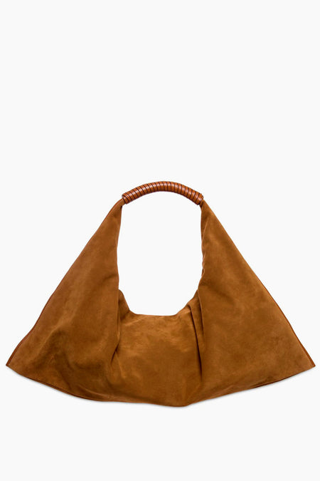 STAUD brown suede shoulder bag features a wide, triangular silhouette and a short leather-wrapped handle. This slouchy design blends style and practicality for a chic everyday accessory.