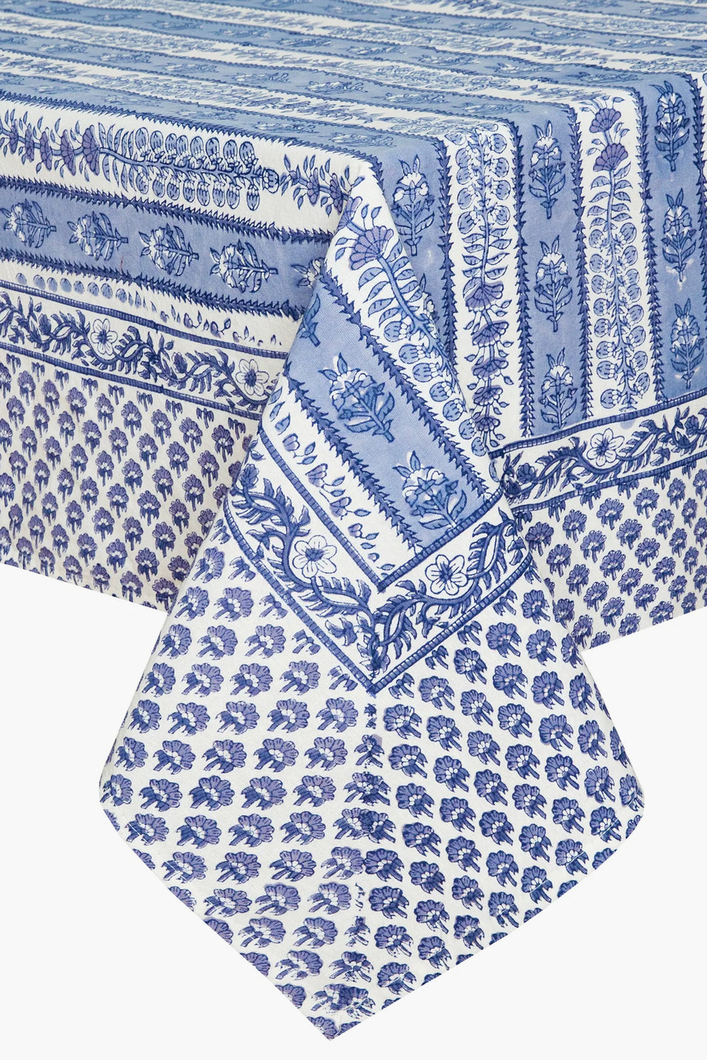 A rectangular table adorned with a blue and white Couleur Nature Paris French tablecloth, featuring handmade linen and botanical designs.