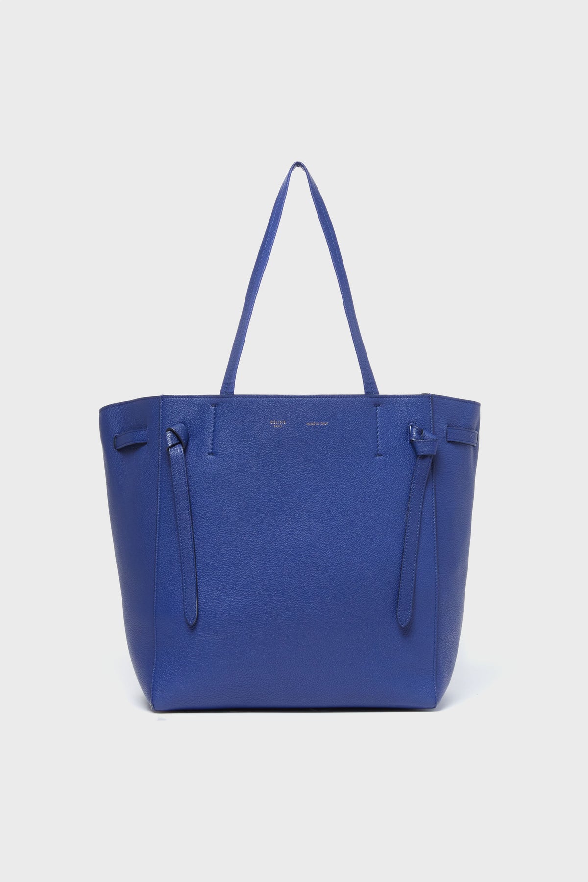 A spacious blue tote from the Tuckernuck Archive Collection, featuring two handles, minimal stitching, and a simple design—a standout among Italian-made leather accessories.