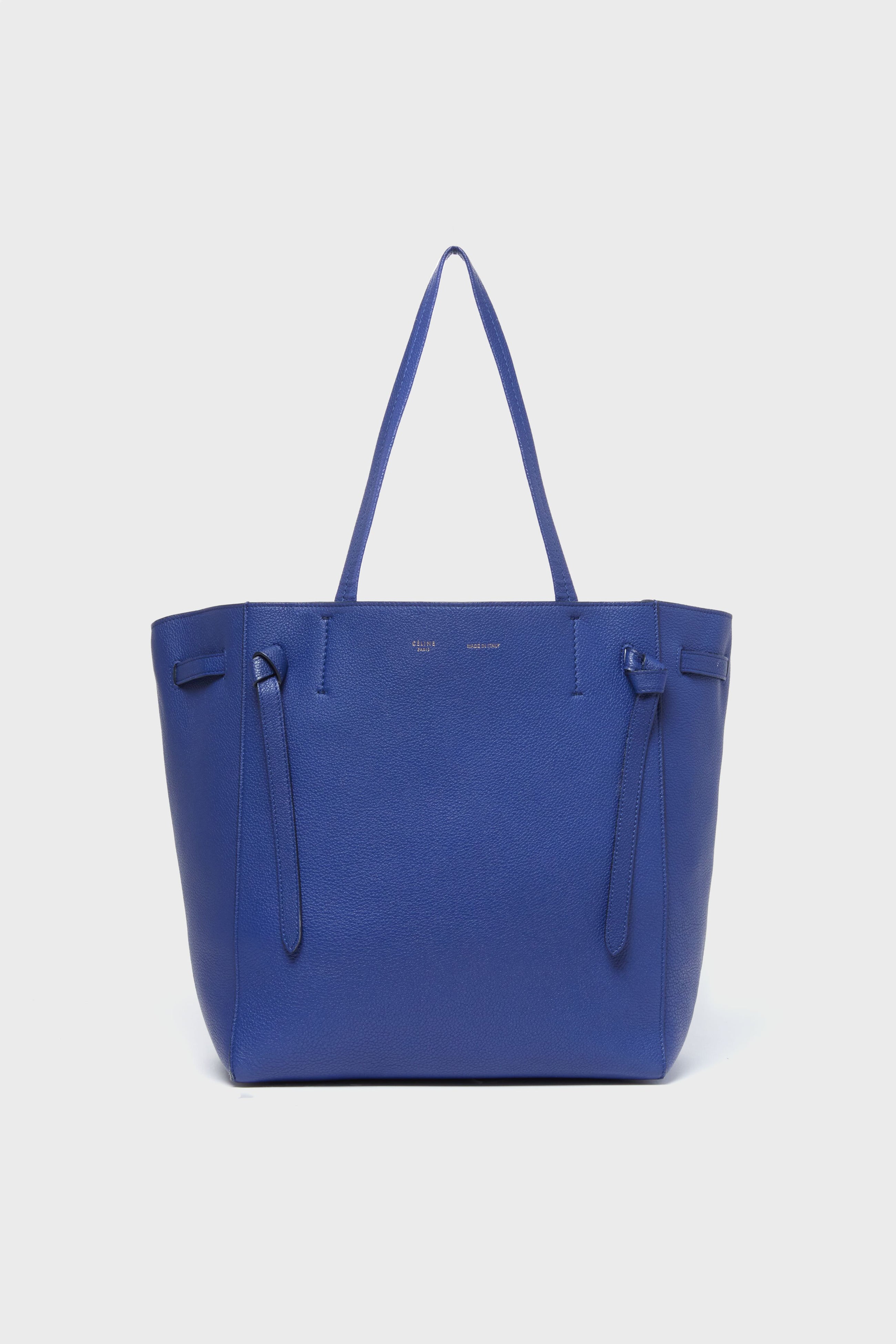 A spacious blue tote from the Tuckernuck Archive Collection, featuring two handles, minimal stitching, and a simple design—a standout among Italian-made leather accessories.