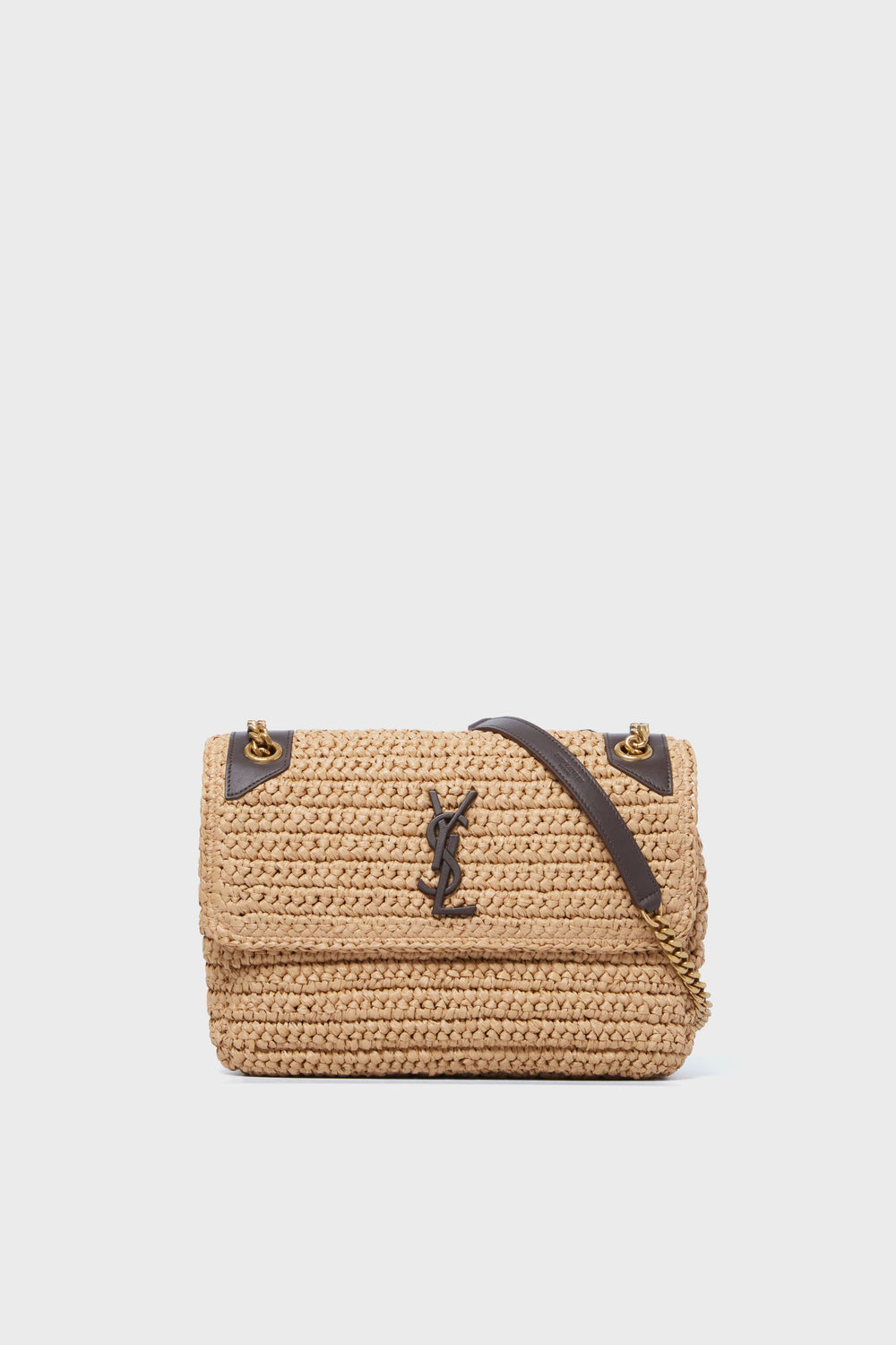 A tan woven Tuckernuck Archive Collection Chain Bag with a flap closure, gold hardware, black leather accents, and a signature logo on the front—an iconic designer crossbody bag.