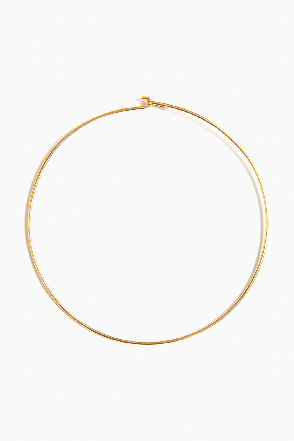 A sleek 14k gold collar chain necklace by Tuckernuck Jewelry, featuring a simple clasp and elegant design.