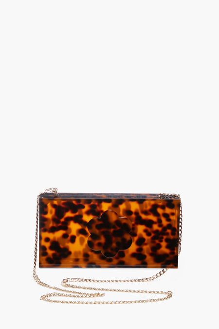 ASHA rectangular tortoise pattern clutch with a cutout floral motif, thin metal chain strap, and chic acrylic design.