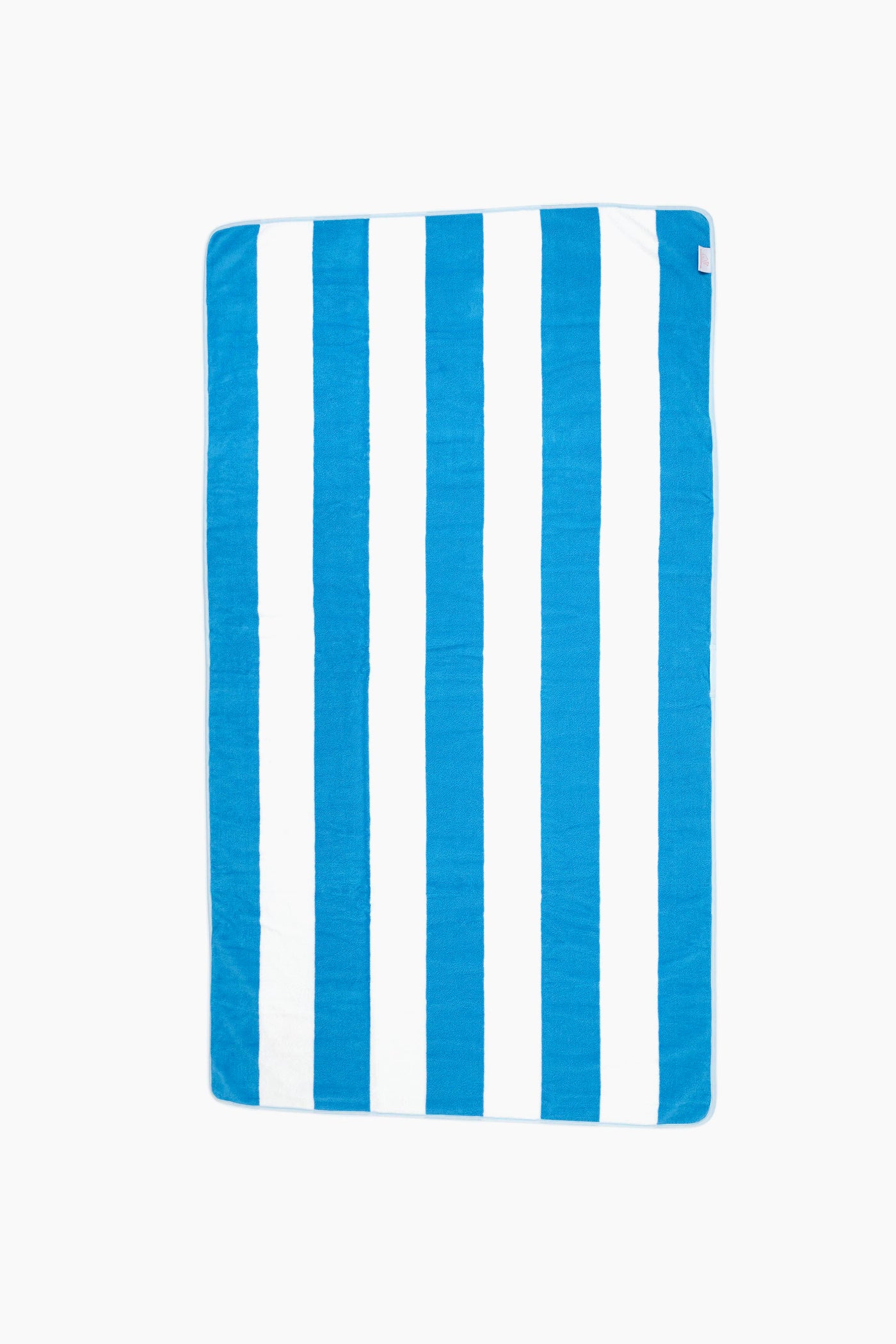 A luxurious rectangular beach towel from Weezie featuring alternating vertical blue and white stripes is shown, perfect for relaxing by the water.