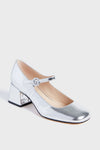 The Marc Fisher silver Mary Jane shoe features a rounded toe, single buckle strap, and a low block heel for added comfort.