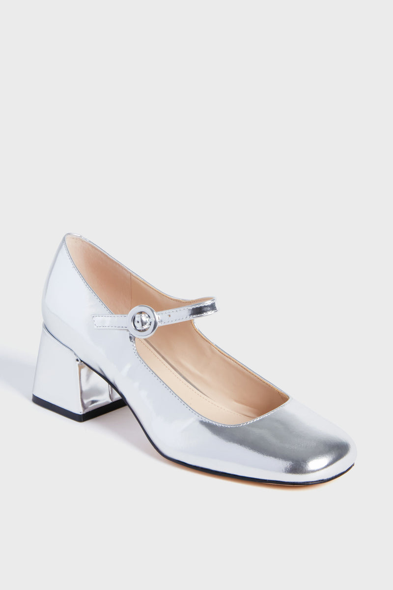 The Marc Fisher silver Mary Jane shoe features a rounded toe, single buckle strap, and a low block heel for added comfort.