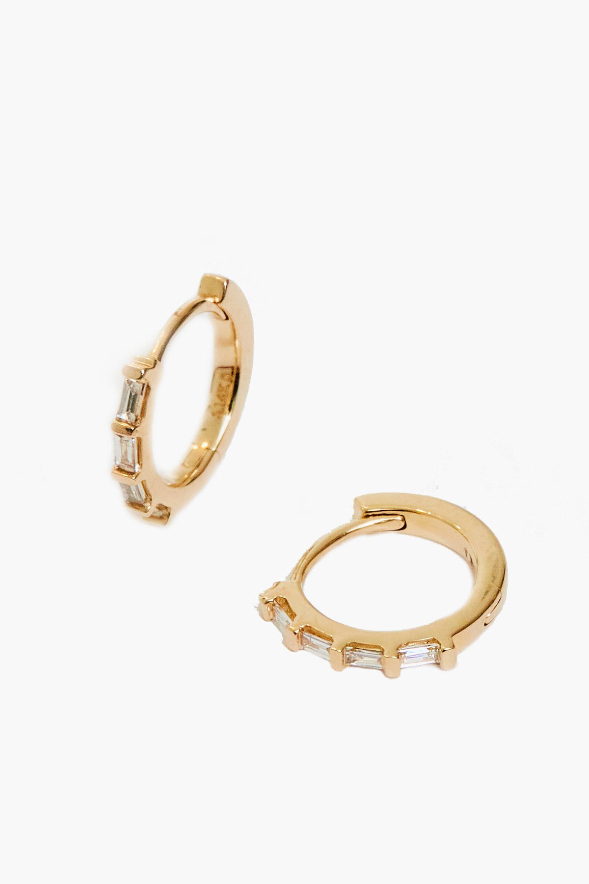 Theodosia's 14k gold earrings feature four rectangular clear stones set along the front, highlighting the elegance of handmade fine jewelry.