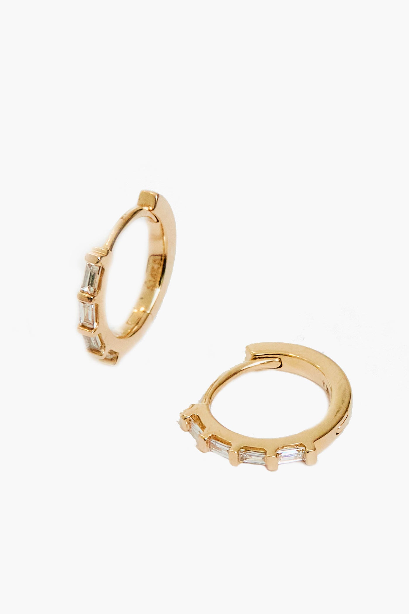 Theodosia's 14k gold earrings feature four rectangular clear stones set along the front, highlighting the elegance of handmade fine jewelry.
