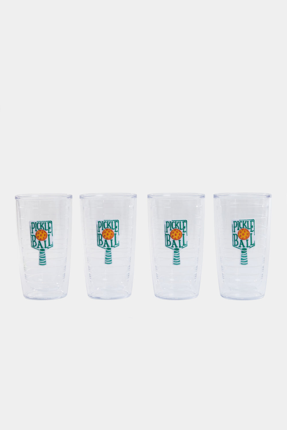 Four clear Tervis Tumblers with paddle-and-ball graphics and "Pickleball" text are arranged in a row. Made from non-breakable drinkware, they're perfect for pickleball fans.