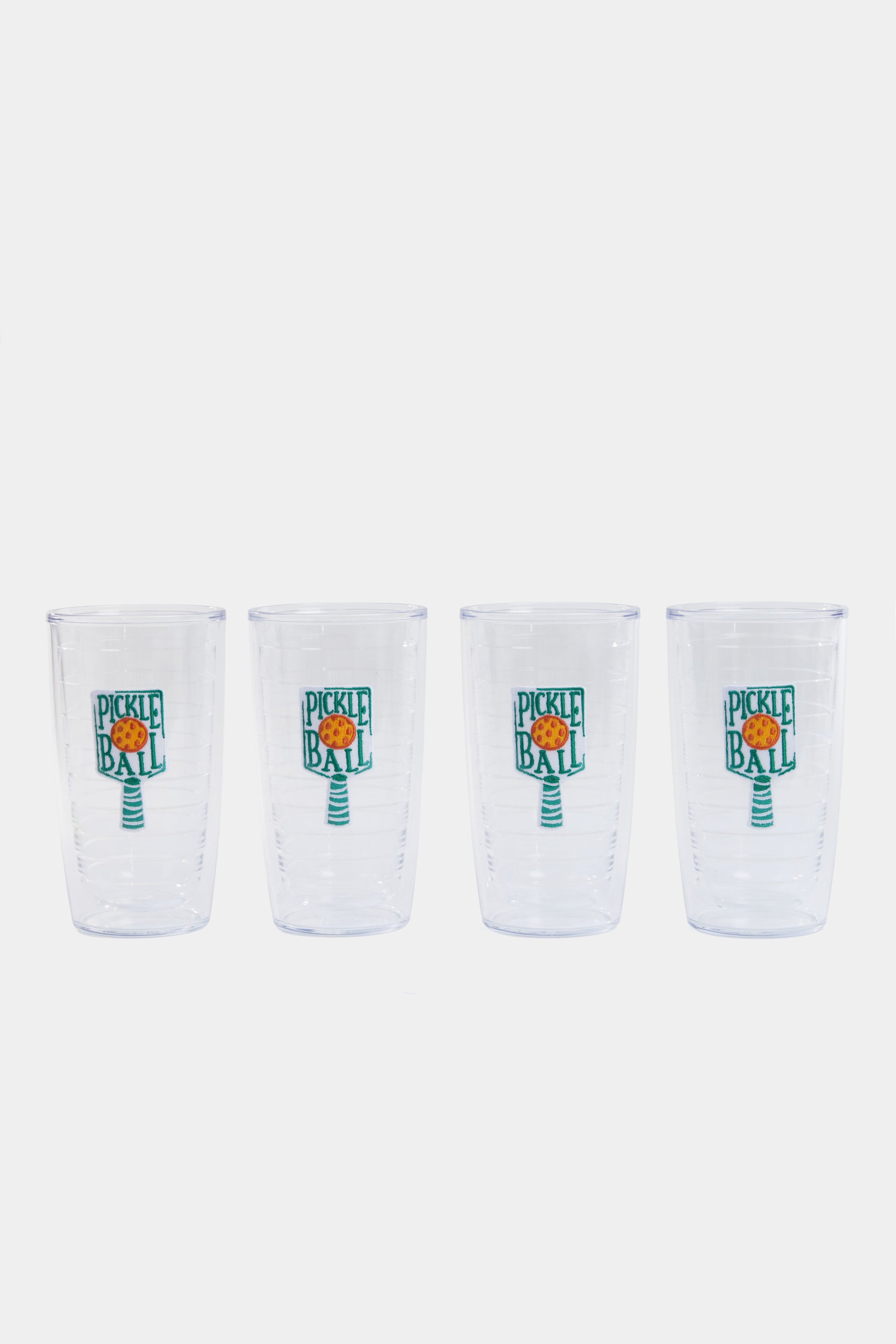 Four clear Tervis Tumblers with paddle-and-ball graphics and "Pickleball" text are arranged in a row. Made from non-breakable drinkware, they're perfect for pickleball fans.