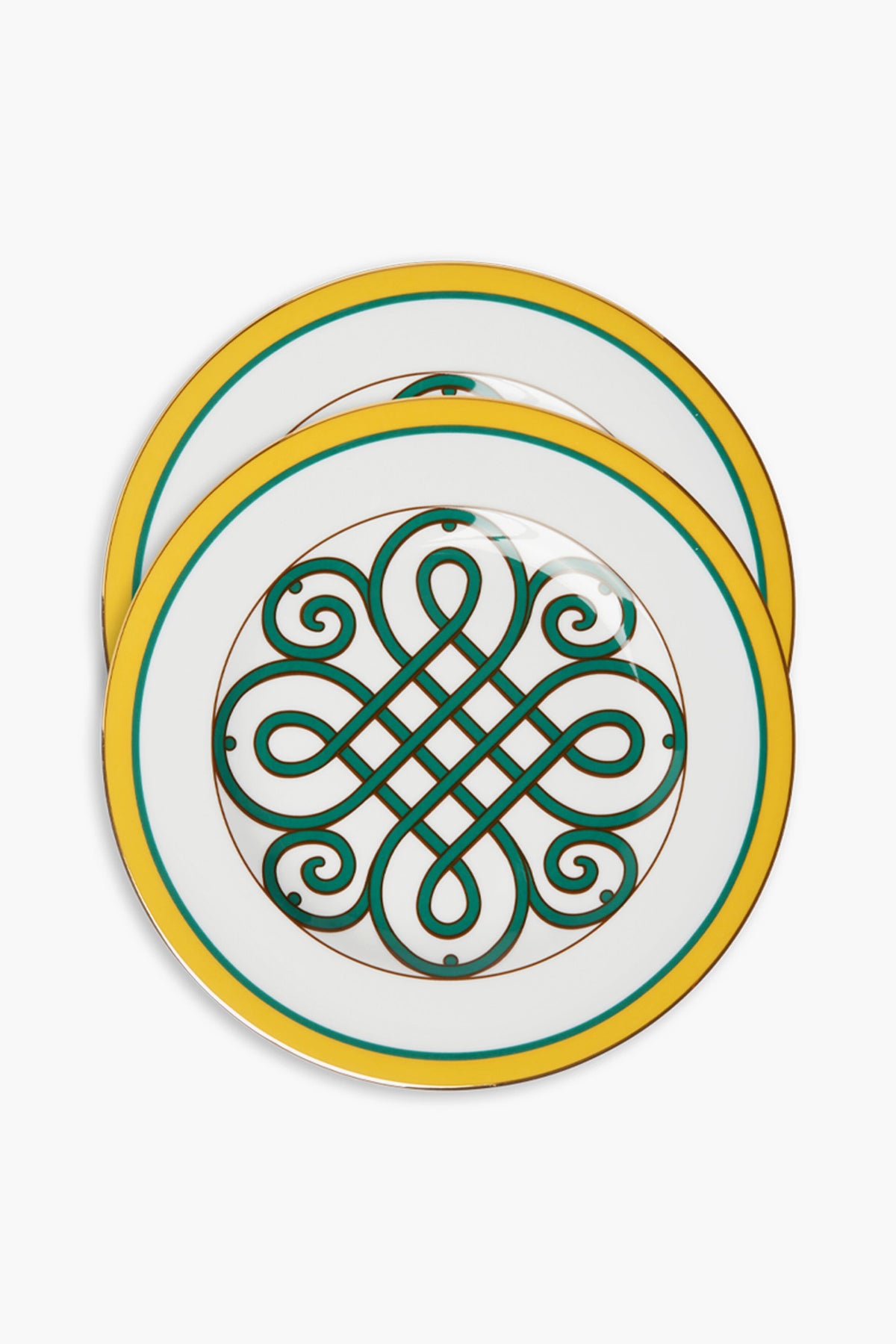 A pair of white Italian porcelain dinner plates by La DoubleJ, each with yellow and green borders, an intricate green and gold geometric center, and one plate featuring an elegant 18k gold rim overlapping the other.