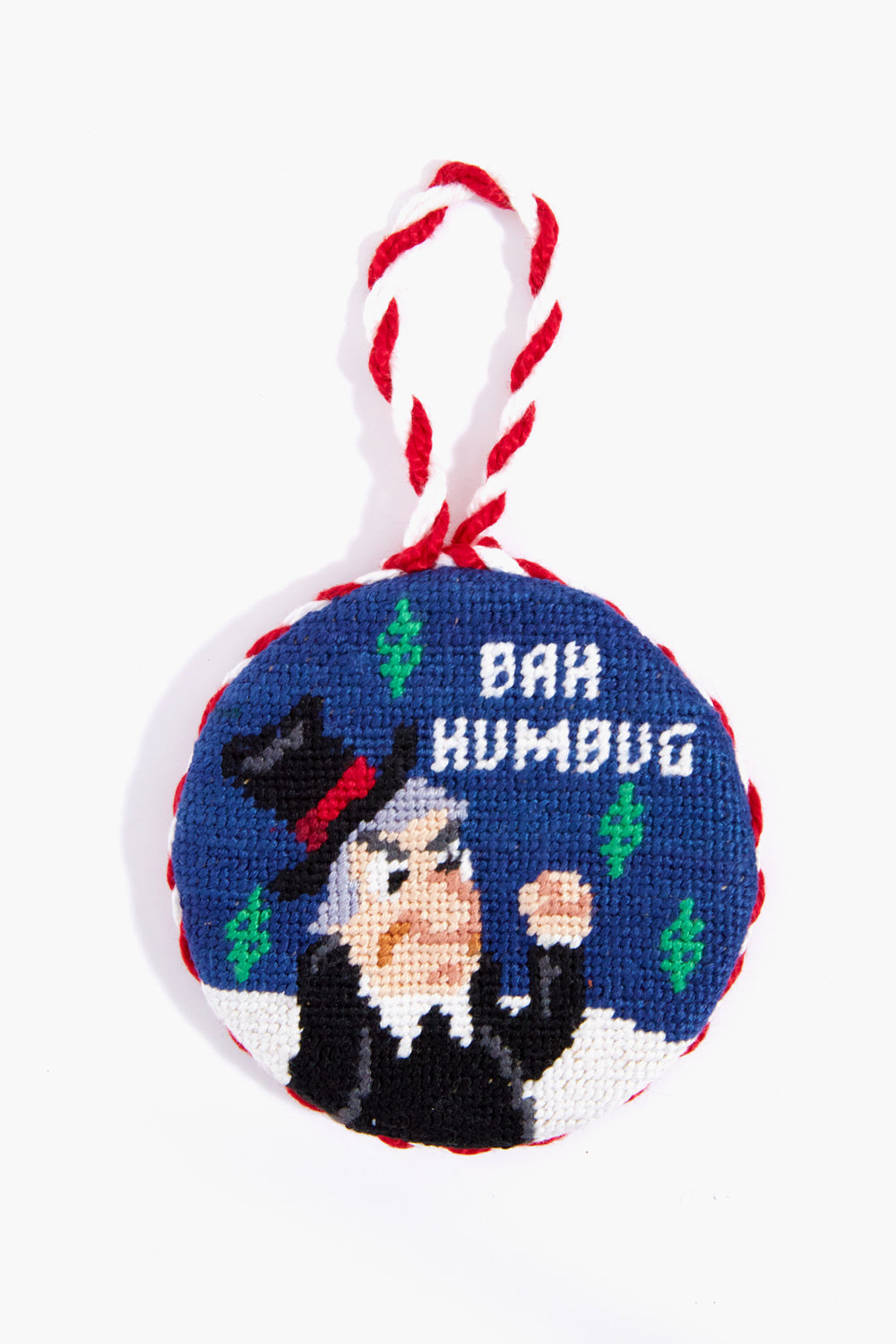 Smathers and Branson round needlepoint ornament with hand-stitched embroidery of a scowling man in a top hat, green accents, and “BAH HUMBUG”—a unique holiday decor piece.