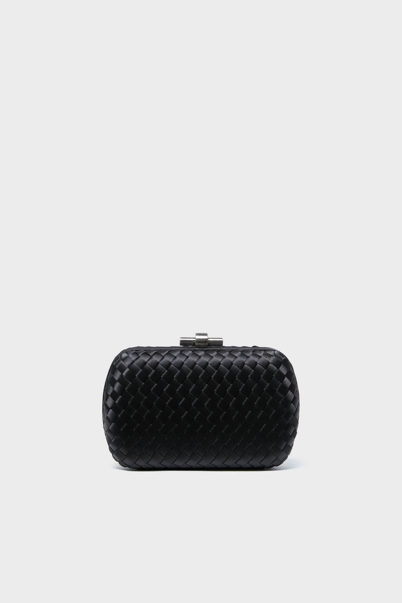 The Olga Berg small black woven clutch features a metallic clasp, making it perfect as an evening bag or a special occasion accessory.