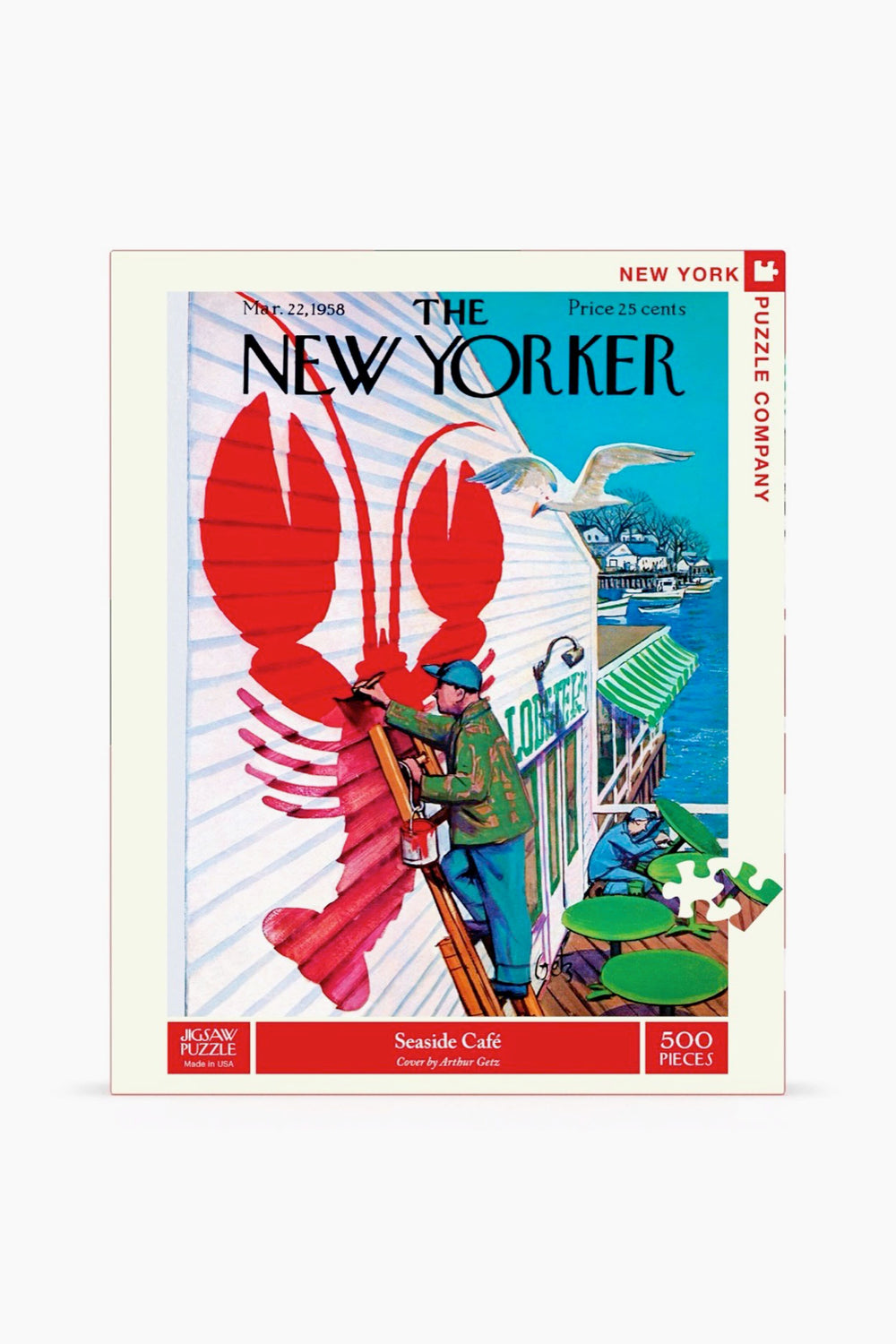 A 500-piece jigsaw puzzle by New York Puzzle Company featuring a New Yorker cover with a man painting a large red lobster at a seaside café, with a seagull and the ocean in the background.