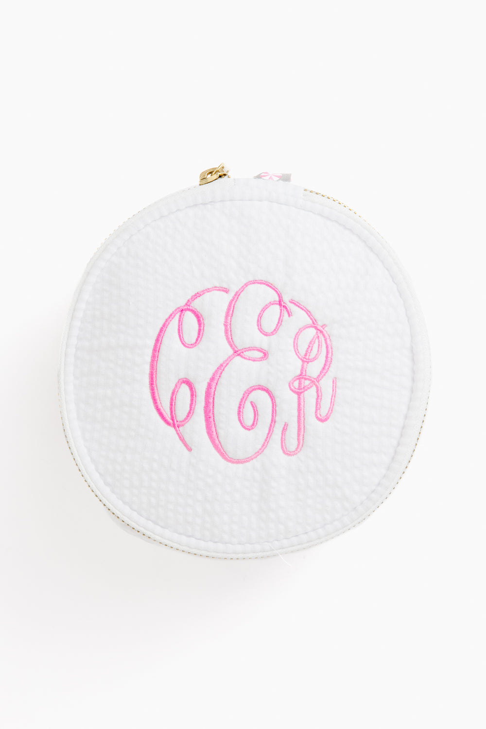 Caton's Wharf round white zippered button bag with a textured surface and pink monogram initials embroidered on top.