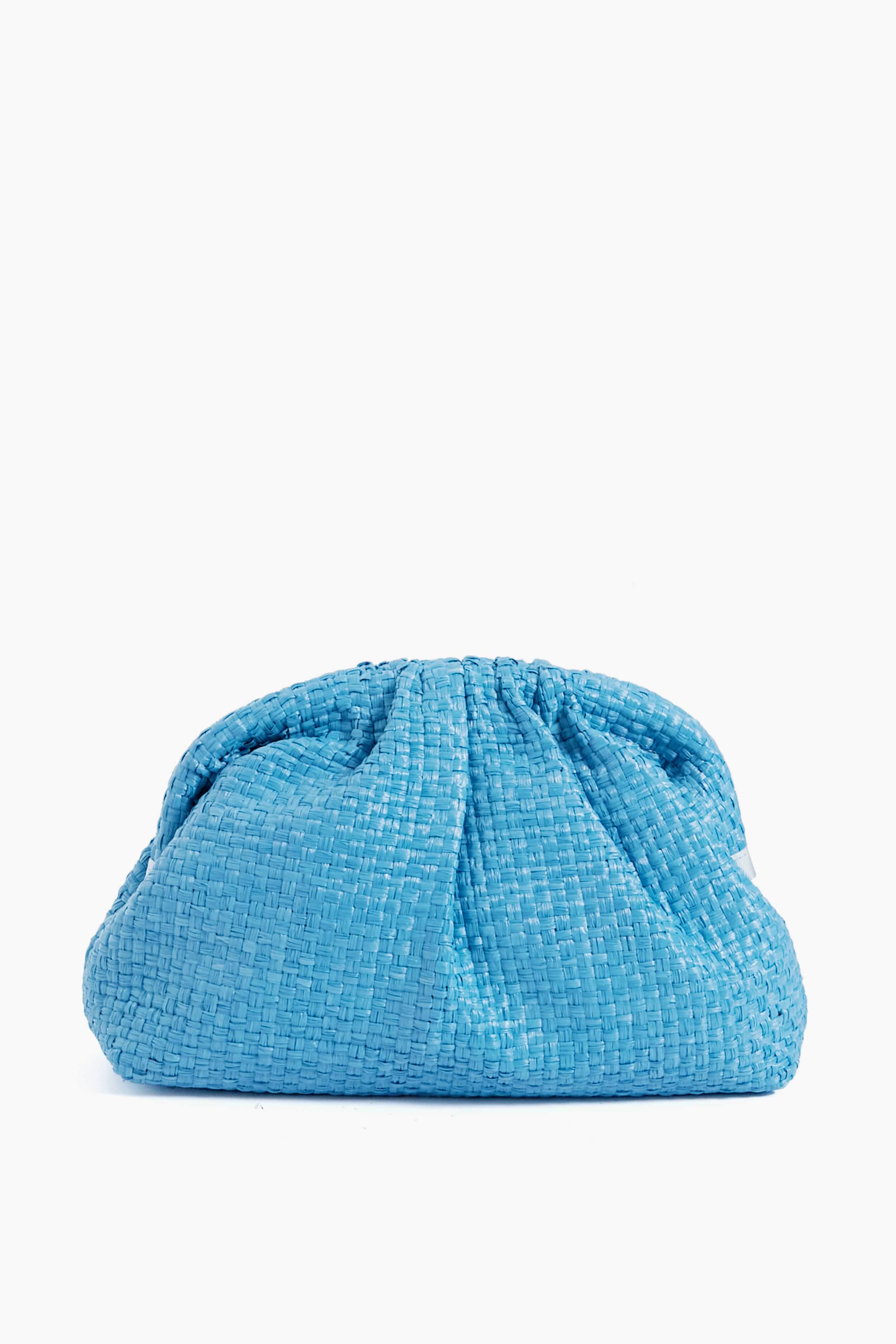 The Maria La Rosa Game Clutch is handwoven from raffia in light blue, featuring a gathered ruched top and a soft pouch silhouette, showcasing exquisite Italian craftsmanship.