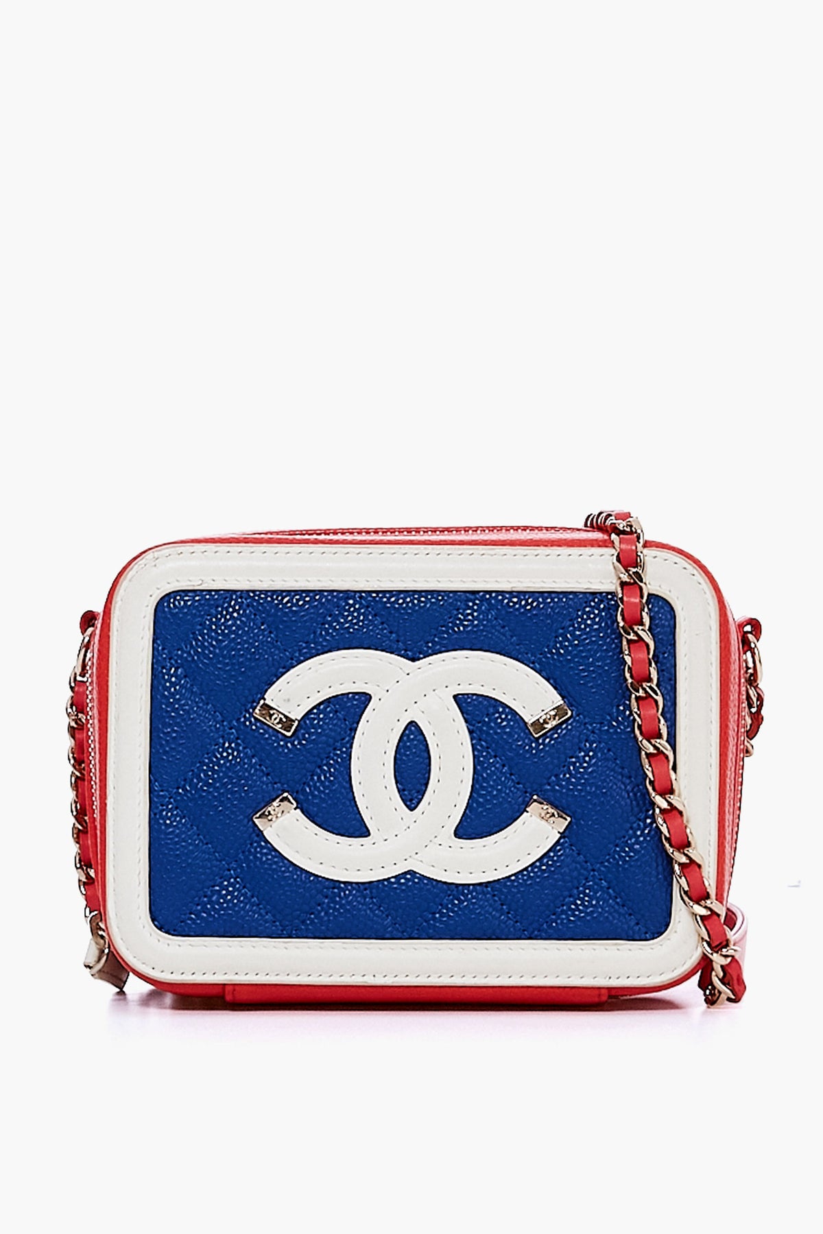 A rectangular blue quilted crossbody from the Tuckernuck Archive Collection with white trim, a white CC logo, pink edges, and a chain strap with alternating pink and silver links.