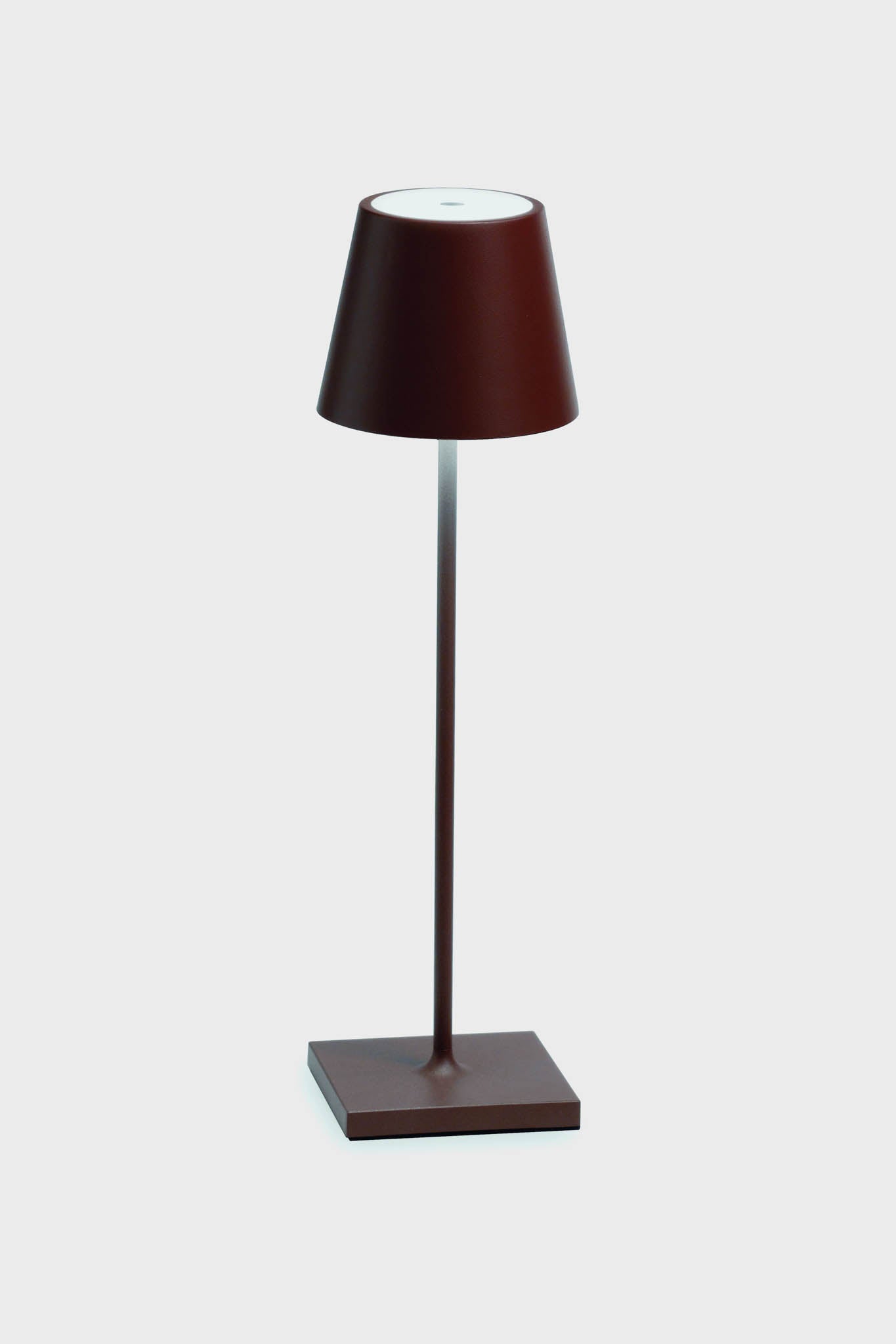 The Zafferano LED table lamp features a modern, minimalist design with a brown base, slender stem, and conical shade, adding elegance to any space.