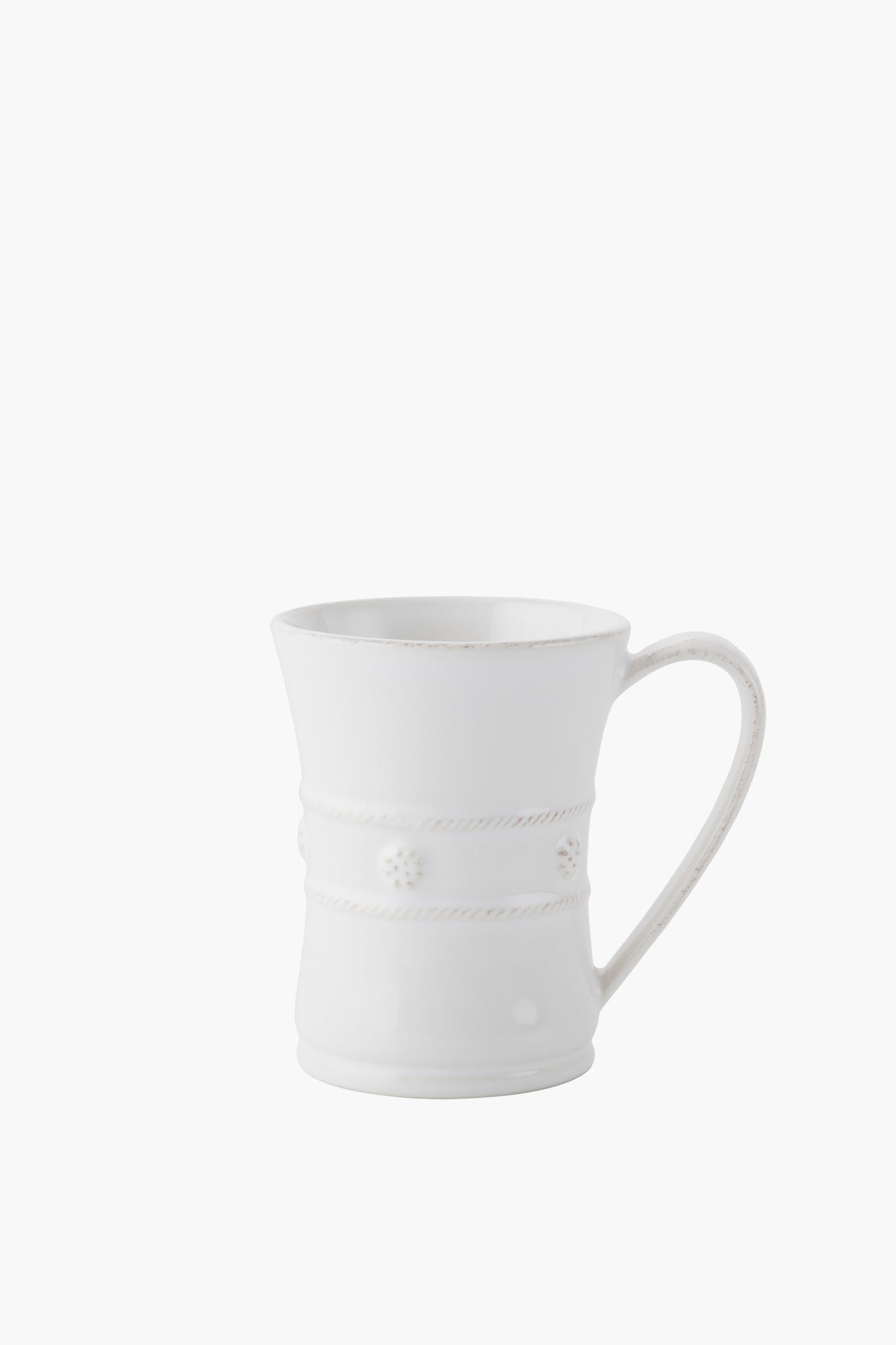 A white Juliska mug crafted from ceramic stoneware features a flared rim, decorative rope-like bands, and small floral accents.